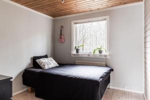 a bedroom with a bed in a room with a window at the Little Oasis In Gothenburg in Gothenburg
