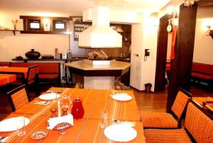 a dining room with a table with plates and glasses at House Trivia in Bansko