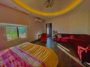 a bedroom with a bed and a living room with a couch at Royal Mariout Villa in King Mariout +26 photos