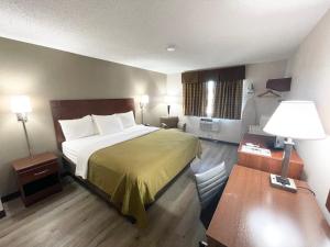 a small hotel room with a bed and a desk at Econo Lodge Cartersville-Emerson Lake Point in Cartersville +33 photos
