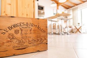 a wooden sign on the floor of a restaurant at Casa Luz in Fuzeta