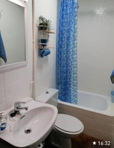 a bathroom with a sink and a toilet and a shower at Spacious family flat centrally located. in Palamós