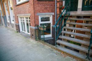 a brick building with a staircase next to a door at Obrecht Welcome in Utrecht