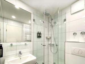 a bathroom with a shower and a sink at VI VADI HOTEL downtown munich in Munich