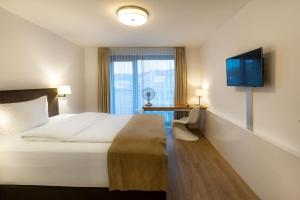 Postel nebo postele na pokoji v ubytování Downtown Vi Vadi Hotel