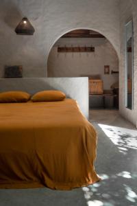 a bedroom with a bed with a yellow blanket at Dechiu in Hoi An