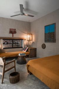 a hotel room with two beds and a couch at Dechiu in Hoi An