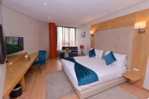 カサブランカにあるLe 135 appart hotelの大きなベッドとデスクが備わるホテルルームです。