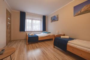 Łóżko lub łóżka w pokoju w obiekcie Tatrzański 22 - Komfortowy dom w górach