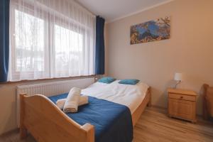 Łóżko lub łóżka w pokoju w obiekcie Tatrzański 22 - Komfortowy dom w górach