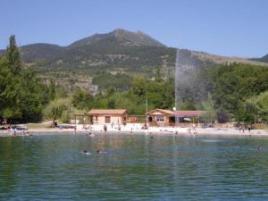 a group of people swimming in the water on a beach at Gîte des Millets en Baronnies in Rosans
