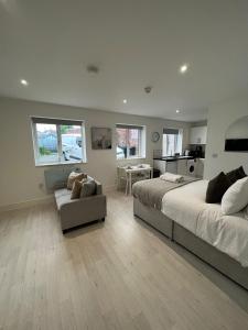 a large bedroom with a bed and a couch at Guest Homes - Eign Street Apartments in Hereford