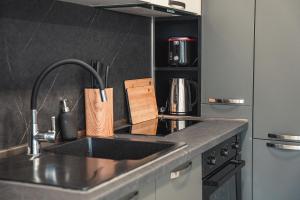 a kitchen with a sink and a counter top at Elite Business Residence with Free Gym Pass, Street Parking and Full Office Setup in Plovdiv