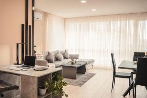 - un salon avec un canapé et une table avec un ordinateur portable dans l'établissement Elite Business Residence, by Holiwork Stays, à Plovdiv