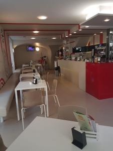 a restaurant with tables and chairs and a counter at Hotel Cumilì in Capo di Ponte