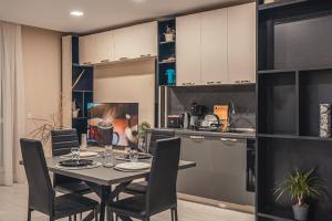 a kitchen and dining room with a table and chairs at Elite Business Residence with Free Gym Pass, Street Parking and Full Office Setup in Plovdiv