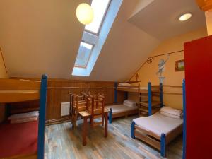 a room with three bunk beds and a skylight at Středisko ekologické výchovy SEVER in Horní Maršov