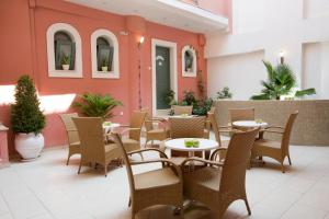 a patio of a restaurant with tables and chairs at Anemolia Apartments in Vasiliki