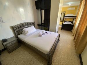 a bedroom with a bed with two pillows on it at Hotel Balmoral in Bucaramanga