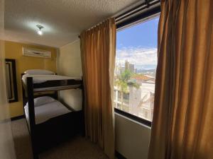 a room with a window with a bed and a balcony at Hotel Balmoral in Bucaramanga +177 photos