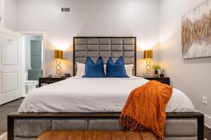 a bedroom with a large bed with blue pillows at The Crescent in New Orleans