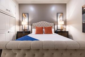 a bedroom with a large bed with orange pillows at The Stella in New Orleans