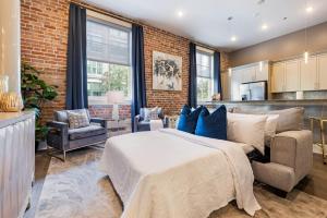 a bedroom with a bed and a brick wall at The Stella in New Orleans