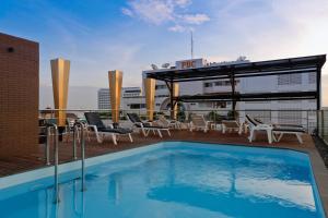 a swimming pool on the roof of a building at Inn House- SHA Extra Plus in Pattaya