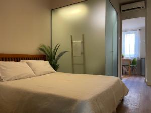 a bedroom with a white bed and a table at ak apartments in Athens