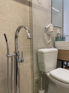 a bathroom with a toilet and a sink and a shower at ak apartments in Athens