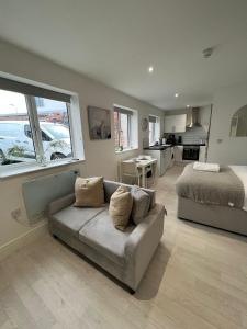 a living room with a couch and a bed at Guest Homes - Eign Street Apartments in Hereford