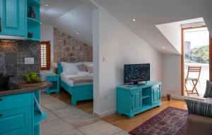 a living room with blue cabinets and a bed at Imperia - Chic! place with balcony in Dubrovnik