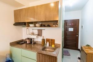 a small kitchen with a sink and a counter at Grand Residences Cebu ETB - Near IT Park and Ayala Cebu in Cebu City