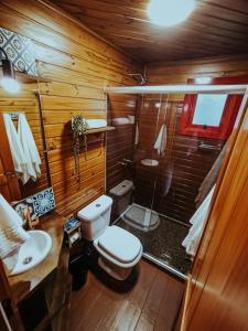 a small bathroom with a toilet and a shower at Hospedaria Locanda 65 - Garibaldi - Serra Gaúcha in Garibaldi +26 photos