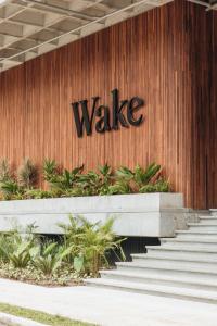 a sign on the side of a building with stairs at Wake - branded residences in Medellín