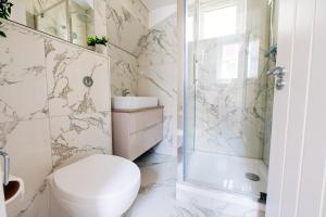 een witte badkamer met een toilet en een douche bij 35a Howard Gardens - Cardiff City Centre in Cardiff