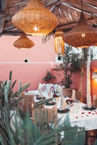 a dining room with a table and chandeliers at Riad Dar Elma And Spa in Marrakesh