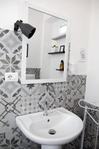 a bathroom with a sink and a mirror at Santu Bustianu in Orgosolo