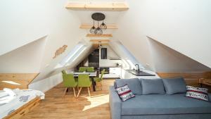 a living room with a blue couch and green chairs at Resorts J Białka Tatrzańska z sauną, Sun & Snow in Białka Tatrzanska