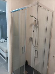 a shower with a glass door in a bathroom at The Essential - Reggia Di Caserta in Caserta
