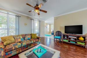 a living room with a couch and a flat screen tv at Emerald View in Destin