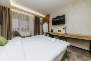 Habitación de hotel con cama grande y TV en Boutique Luxury Apartments en Kragujevac