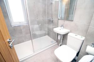 a bathroom with a shower and a toilet and a sink at Long stay offer - Stylish 1 bed flat with parking in Bristol