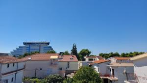 a city with a tall building in the background at Apartments Gardijan in Vodice