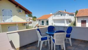 a patio with chairs and a table on a balcony at Apartments Gardijan in Vodice