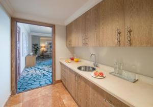 a kitchen with wooden cabinets and a sink and a hallway at Atlantis, The Palm in Dubai