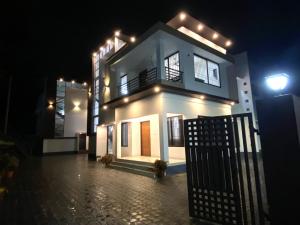 a house with lights on top of it at night at Urbane Cove in Trivandrum