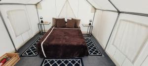 a bedroom with a large bed in a tent at Tentrr Signature Site - Little Creek Ranch in Waynesboro