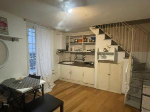 a kitchen with a staircase and a table in a room at Incantevole Monolocale a Lucca nel Centro Storico - EstateGuard Group in Lucca