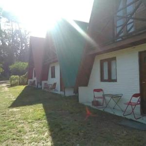 a group of chairs sitting outside of a house at Per a Tu in Punta del Este